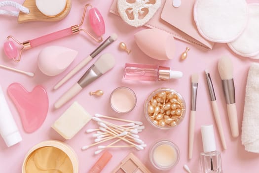 Skin care and makeup products on light pink, top view, banner. Flat lay with natural beauty products and decorative cosmetics. Everyday woman face care routine. Pastel composition
