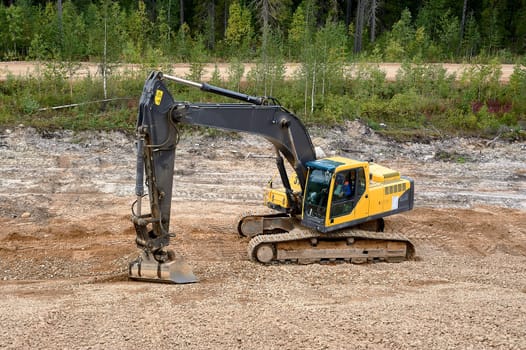 Excavator digs the ground. High quality photo