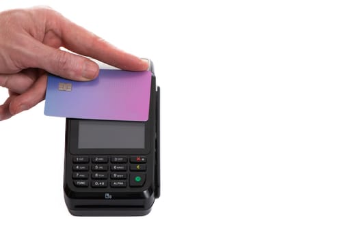 Attached plastic card to the payment terminal with a man's hand on a white isolated background, copy space. High quality photo