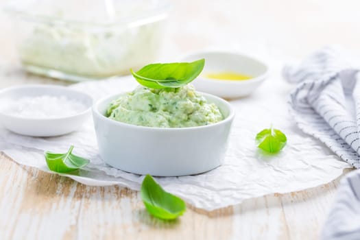 Homemade avocado spread with herbs with salt and olive oil