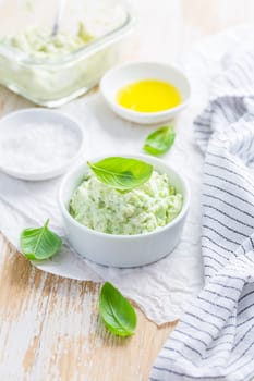 Homemade avocado spread with herbs with salt and olive oil