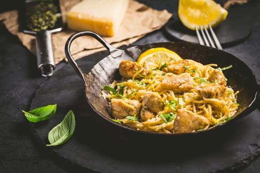 Lemon Chicken Pasta in cast iron pan with basil and Parmesan.