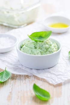 Homemade avocado spread with herbs with salt and olive oil