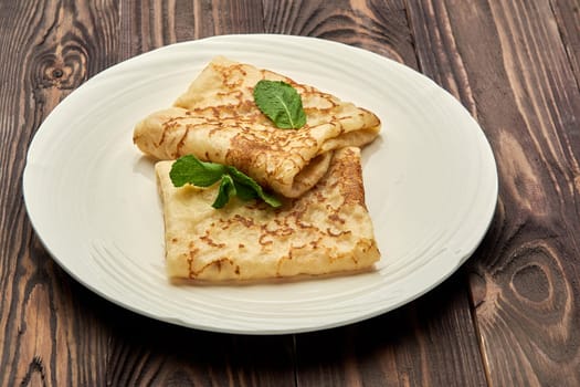 delicious juicy pancakes lie on a white plate. High quality photo