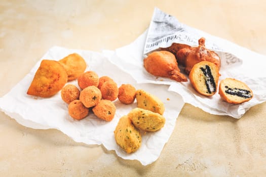 Finger food and street food - assortment of Arancini rice balls, fried curd balls, cod pies