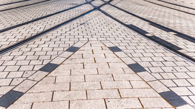 Crossroad of tram rail lines amd road in street
