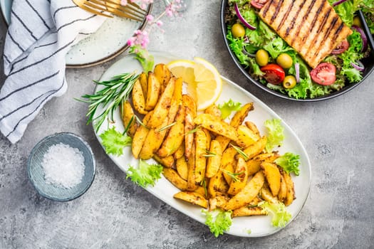 Potato wedges, oven roasted with freshly mixed salad and grilled cheese