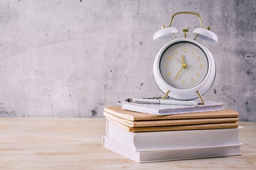 Time managament concept for schoolers and students. Books with clock