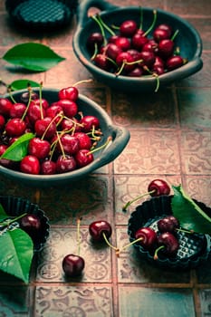Fresh raw organic sour cherry in bowl on kitchen table