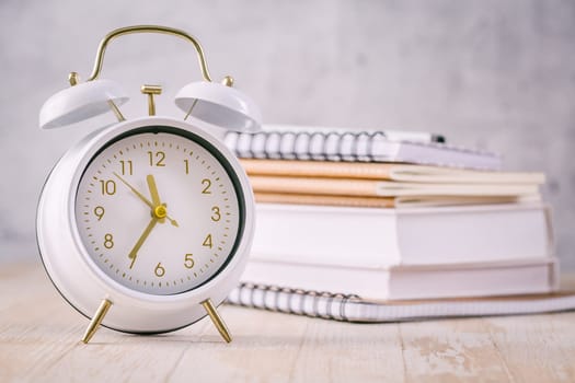 Time managament concept for schoolers and students. Books with clock