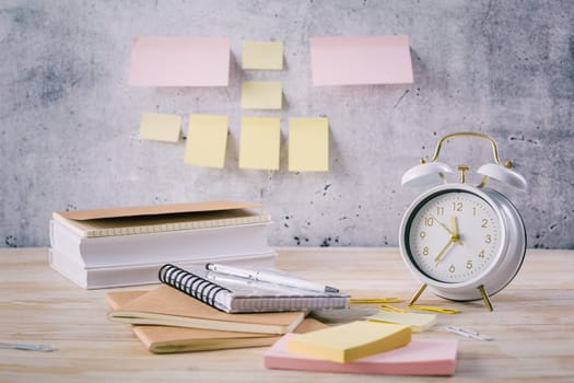 Time managament concept in office. Books, notepads with stickers