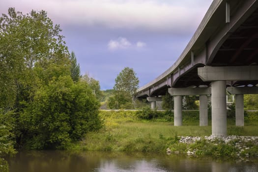 bridge over river in nature green trees landscape transportation and environment