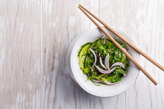 Traditional Japanese Sunomono salad with cucumber and wakame seaweed and sesame seeds