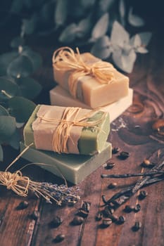 Natural organic soap bars with vanilla, coffee beans and eucalyptus on wooden background