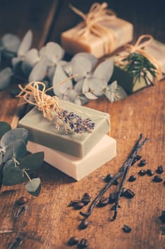 Natural organic soap bars with vanilla, coffee beans and eucalyptus on wooden background