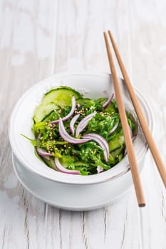 Traditional Japanese Sunomono salad with cucumber and wakame seaweed and sesame seeds