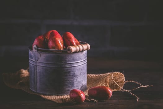 Organic raw red potatoes on wooden background