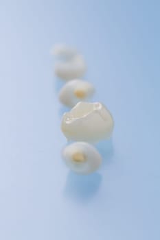 Primary teeth on blue background. Baby teeth, concept of dental care and hygiene