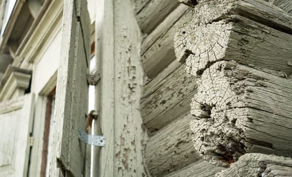 A part of old wooden building with wooden window and old timber