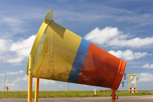 a colourful rubbish containers for cyclists, with blue sky in the background.ein bunter Müllbehälter für Radfahrer, mit blauem Himmel im Hintergrund.