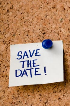Save the date message on sticker note pin on cork office board. Reminder for registration or appontment written on card. Business concept.