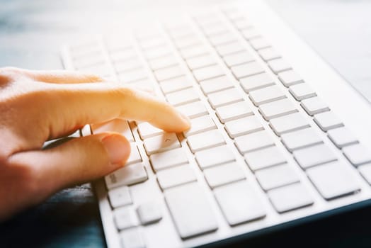 Closeup of peroson hand typing on computer keyboard device.Internet business and modern techology background concept. Woman using office computer for freelance work, e commerce,e mail and e banking.