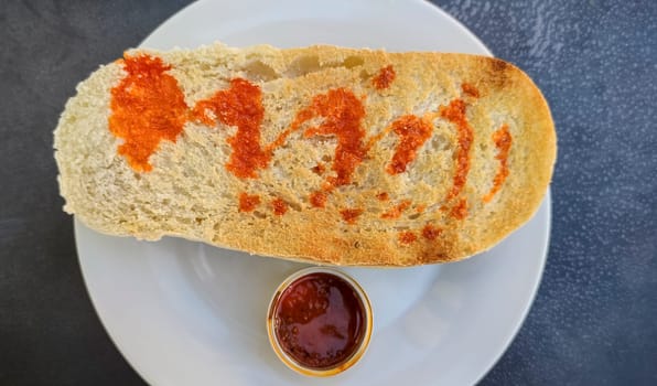 Iberian cachuela bread toast. Single-serve cachuela container