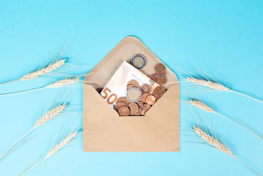 Envelope with wheat and Euro banknotes, food shortage and increasing prices, poverty through inflation