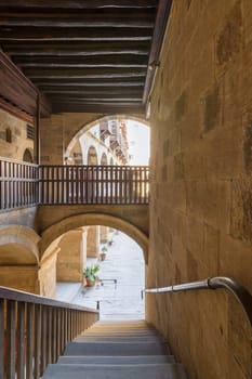 Staircase going down with wooden balustrade at caravansary - Wikala - of Bazaraa, suited in Gamalia district, Medieval Cairo, Egyp