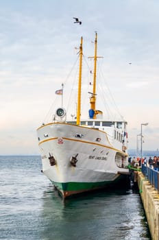 Istanbul, Turkey - March 3 2013: Passengers unloading from local ferry terminal of Buyukada - Princess Island - with calm sea and clear sky