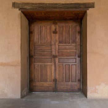 Grunge wooden aged door on grunge stone wall, Medieval Cairo, Egypt