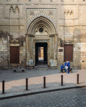 Cairo, Egypt- December 12 2015: Entrance of theological school and Mausoleum of Sultan Qalawun, Moez Street