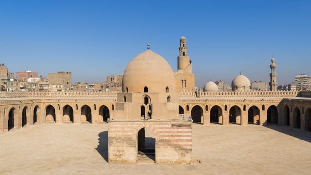 Courtyard of Ibn Tulun public historical mosque with ablution fountain and the minaret, Sayyida Zaynab district, Medieval Cairo, Egypt