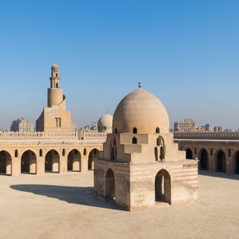 Courtyard of Ibn Tulun public historical mosque with ablution fountain and the minaret, Sayyida Zaynab district, Medieval Cairo, Egypt
