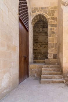 Stone staircase leading to vaulted entrance at stone bricks wall, Medieval Cairo, Egypt