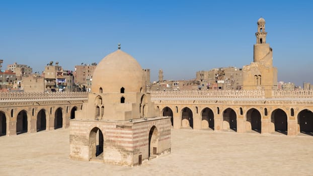 Courtyard of Ibn Tulun public historical mosque with ablution fountain and the minaret, Sayyida Zaynab district, Medieval Cairo, Egypt