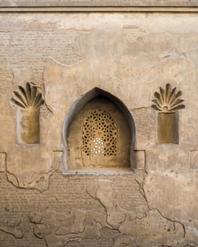 Perforated arched stucco window decorated with floral patterns, one of the traditions of the Mamluk era, Outer wall of Mosque of Ibn Tulun, Sayyida Zaynab district, Medieval Cairo, Egypt