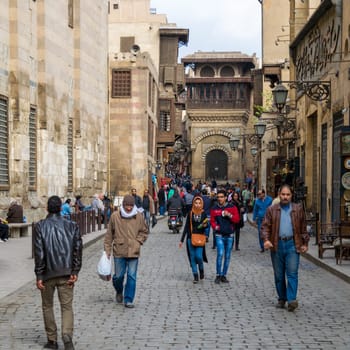 Cairo, Egypt- January 2 2016: Moez Street with local visitors and Sabil-Kuttab of Katkhuda historic building at the far end, Gamalia district, Old Cairo