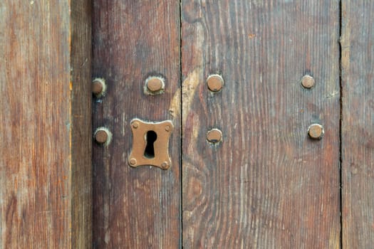 Vintage keyhole in old wooden grunge door
