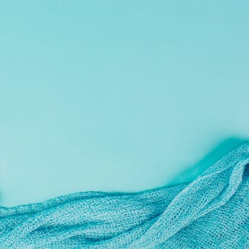 Blue colored background with a woven cloth, copy space for text