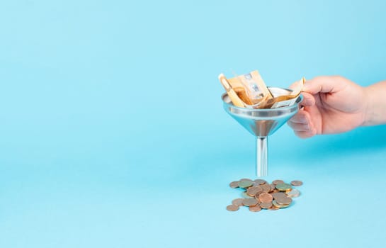 Inflation and financial crash, euro banknotes in a funnel become coins, economic development and increasing prices, worthless money