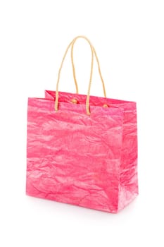Pink nacre gift bag with raised handles. Package is made of crepe paper. Consumer pack ready for logo design. Advertising and branding. Isolated on a white background.