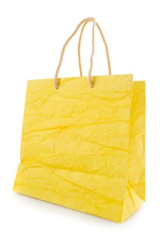 Yellow gift bag made of corrugated paper with raised handles. Consumer pack ready for logo design. Advertising and branding. Isolated on a white background.