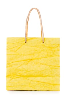 Yellow gift bag made of corrugated paper with raised handles. Consumer pack ready for logo design. Advertising and branding. Isolated on a white background.