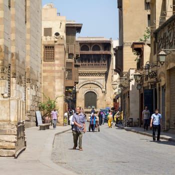 Cairo, Egypt- January 2 2016: Moez Street with local visitors and Sabil-Kuttab of Katkhuda historic building at the far end, Gamalia district, Old Cairo