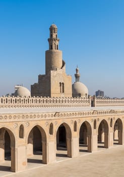 Minaret Ibn Tulun Mosque with helical outer staircase with dome of Amir Sarghatmish mosque in the background, Sayyida Zaynab district, Medieval Cairo, Egypt
