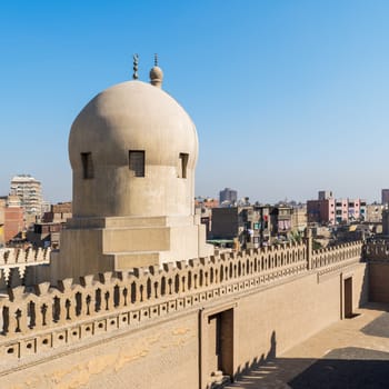 Fence of Ibn Tulun Mosque revealing dome of Amir Sarghatmish mosque, Sayyida Zaynab district, Medieval Cairo, Egypt