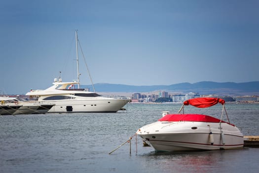 Yachts parked near a pear. Summer seascape. Travel and Vacation Concept. Beautiful sunny day