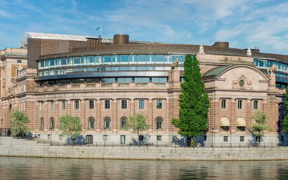 The Swedish Parliament House, Riksdagshuset, located on the island of Helgeandsholmen, Old town, or Gamla Stan, Stockholm, Sweden, in a summer day