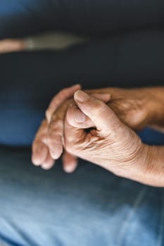 Happy romantic senior couple in love holding hands at home